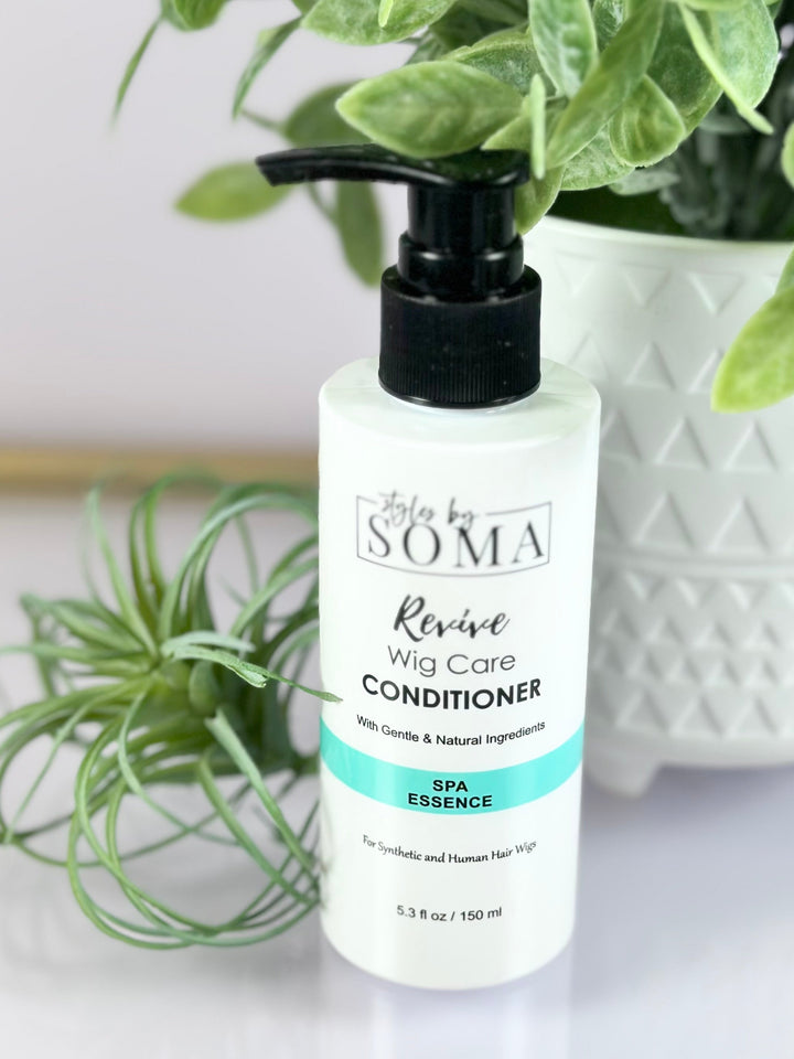 Bottle of Soma Revive Wild Care Conditioner with plants in the background